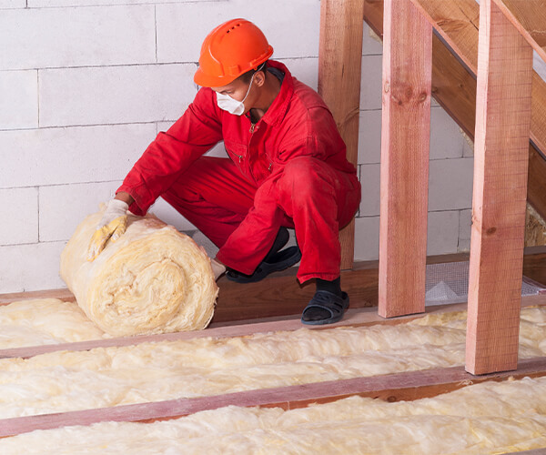 Contractor insulating an attic